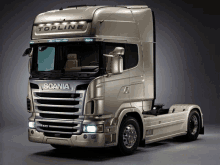 a silver scania truck with the word topline on it