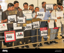 a group of men holding signs that say jas