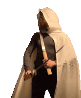 a man in a hooded cape holds a sword