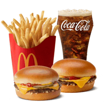 a glass of coca cola sits next to a bucket of french fries and two hamburgers