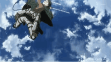 a person is flying through a blue sky with a sword .