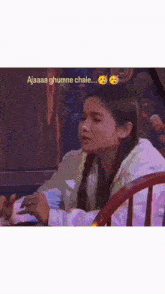 a woman is sitting in a chair with a caption that says ajaaa ghumne chale ...