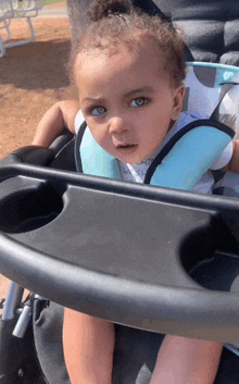 a baby in a high chair with a shirt that says ' i 'm a whale ' on it