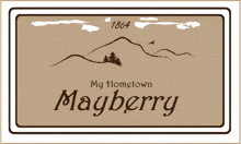 a sign for my hometown mayberry with a mountain in the background