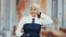 a woman with blonde hair is wearing a white shirt and tie .
