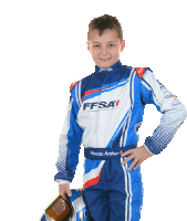 a young boy wearing a blue and white ffsai race suit