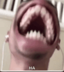a close up of a person 's mouth with their mouth open and ear buds .