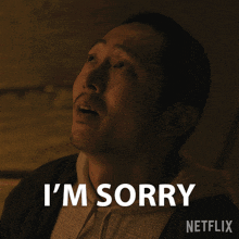 a man says i 'm sorry with a netflix logo behind him