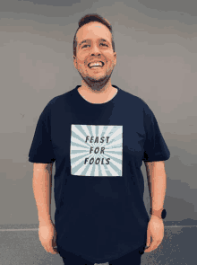 a man is wearing a shirt that says feast for fools