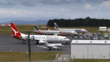 jetstar and qantas airplanes are parked on a runway