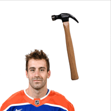 a hockey player with a hammer on his head in front of his head