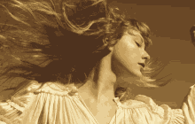 a woman 's hair is blowing in the wind in a sepia tone photo