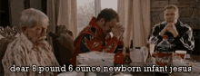 a man in a race car jacket sits at a table with two older women and a coca cola bottle