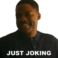 a man in a black shirt with the words just joking on his face