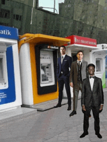 a man in a suit stands in front of an atm that says atik