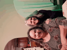 two women are posing for a picture in a kitchen