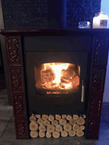 a fireplace with a stack of logs underneath it