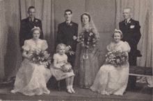 a bride and groom pose with their wedding party