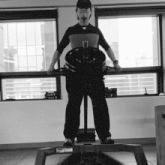 a man is holding a barbell with a weight on it