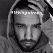 a black and white photo of a man with the words staying strong