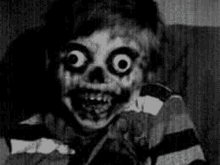 a black and white photo of a child with a skeleton face and big eyes .