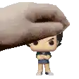a hand is holding a funko pop of a boy with his arms crossed on a white background .