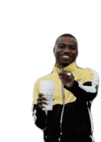 a man in a yellow and black jacket is holding a cup that says rockstar on it