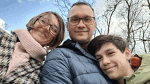 a man and a woman are posing for a picture with their son