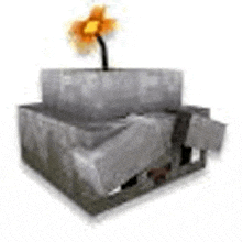 a flower is growing out of a block in a box .