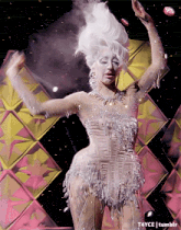 a woman in a white dress is dancing on a stage with t4yce tumblr in the bottom right corner