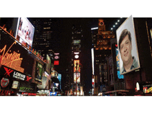 a billboard for loews theatres hangs in the middle of a city street