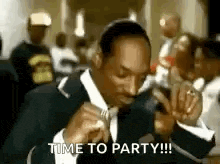 snoop dogg is wearing a suit and tie and saying `` time to party !!! '' .