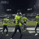 a football player with the number 83 on his jersey is dancing on the field