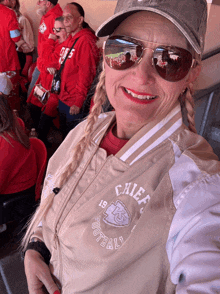 a woman wearing sunglasses and a chiefs jacket