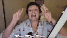 a woman with a tattoo on her neck is giving a peace sign while wearing headphones