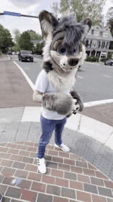 a person in a furry wolf costume is standing on a brick sidewalk in front of ocean bridge rd