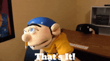 a puppet says that 's it while holding a pencil in his mouth