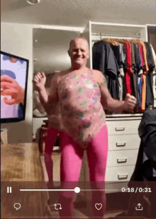 a man in pink pants is dancing in a room