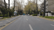 a blue bus is driving down a street with trees