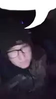 a blurry picture of a person wearing glasses and a hat that says mtn