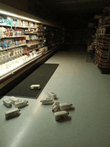 bottles of milk are laying on the floor in a store