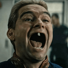 a man is making a funny face with his mouth open and his tongue hanging out .