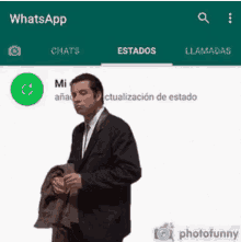 a man in a suit is standing in front of a whatsapp app