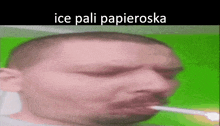 a man is smoking a cigarette with the words ice pali papieroska written on the bottom