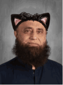 a man with a beard wearing a cat hat with pink ears