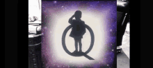 a silhouette of a child standing in a circle with the letter q in the middle