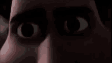 a close up of a person 's eyes in the dark