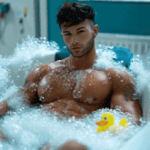 a man is taking a bath with a yellow rubber duck