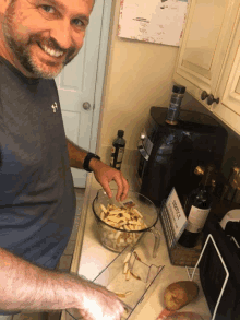 a man is preparing french fries in a kitchen with a sign that says service