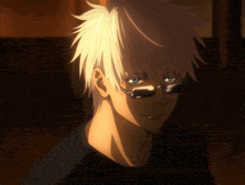 a man with white hair and glasses is smiling